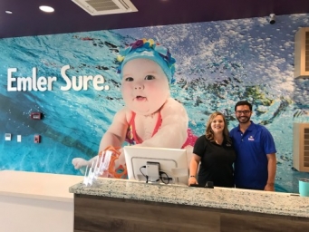 Two members of the Emler team at the front desk for the Houston - Clear Lake swim school